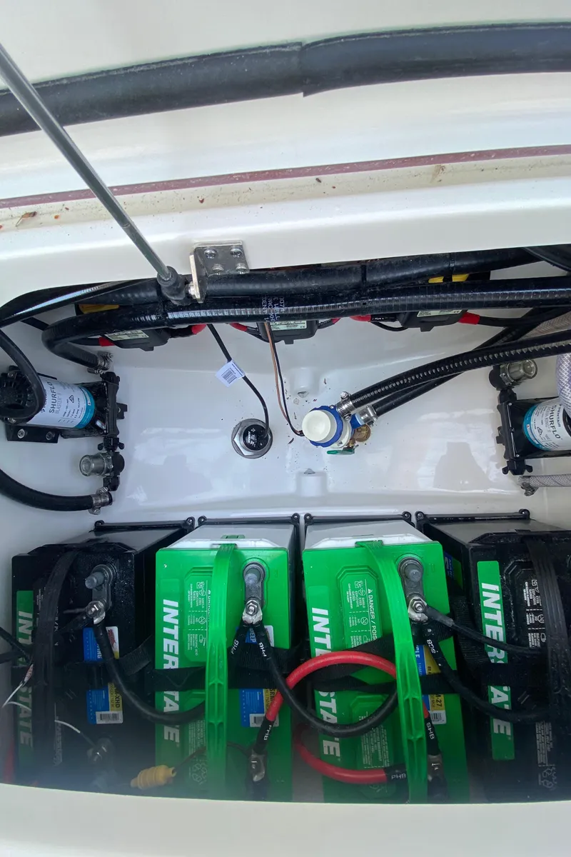 Slide: The Image of 2023 Sea Pro 259 boat battery compartment with Interstate batteries. - 19