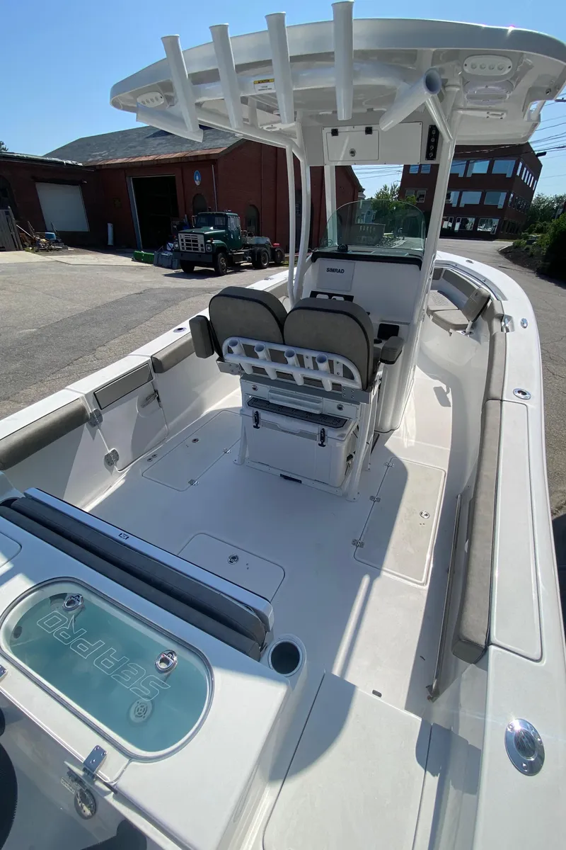 Slide: The Image of 2023 Sea Pro 259 boat with center console and seating, docked near buildings. - 6