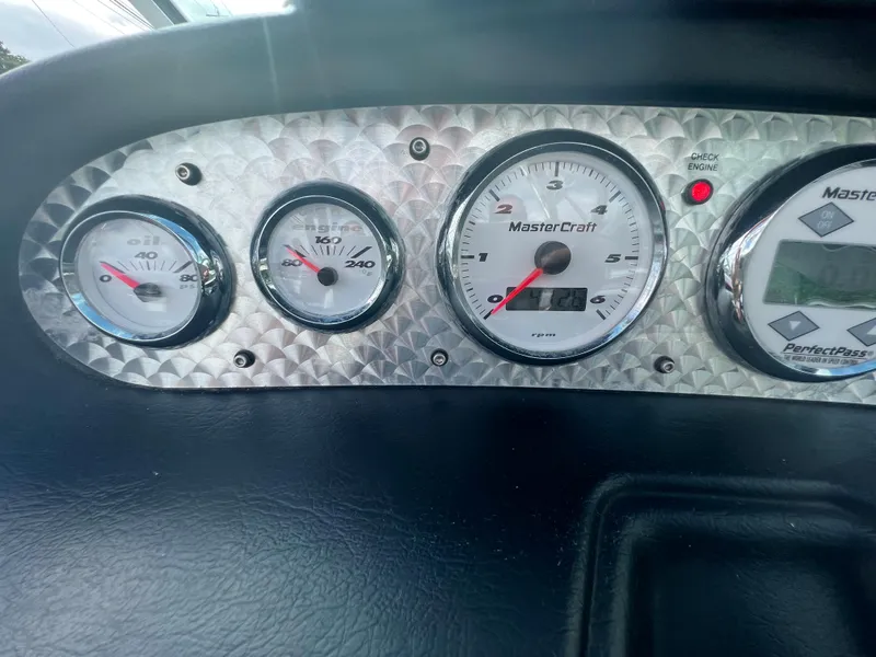 Slide: The Image of 2004 MasterCraft X30 boat dashboard with gauges and controls. - 10