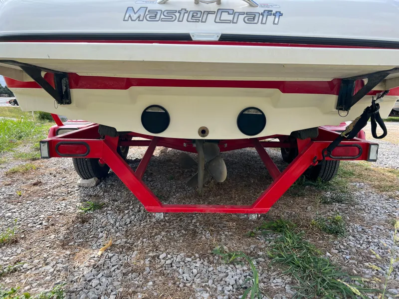 Slide: The Image of 2004 MasterCraft X30 boat on red trailer, rear view. - 4