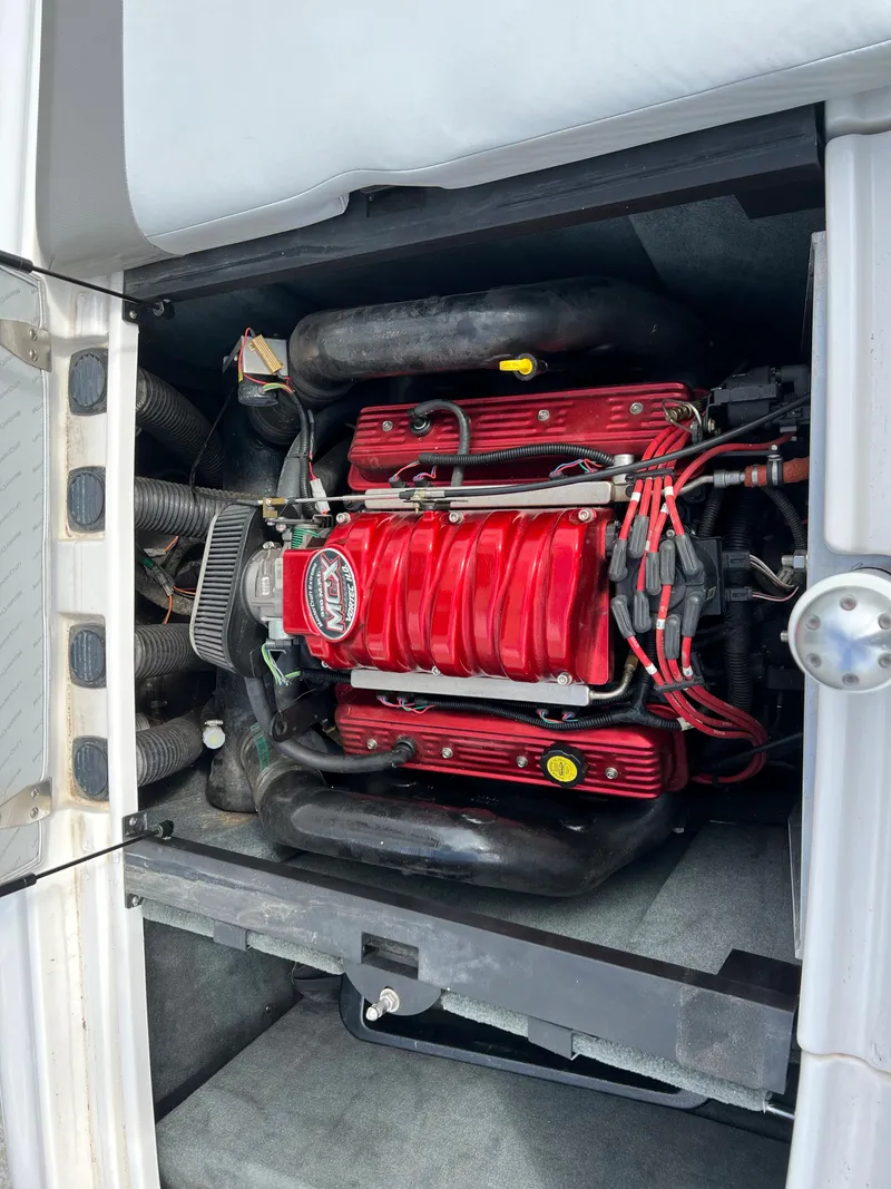 Slide: The Image of 2004 MasterCraft X30 boat engine with red components and wiring. - 5