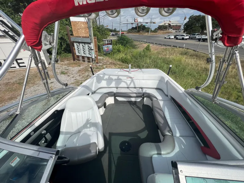 Slide: The Image of 2004 MasterCraft X30 boat interior with red canopy and white seating. - 8