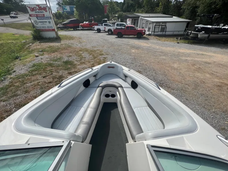Slide: The Image of 2004 MasterCraft X30 boat with spacious seating, parked on gravel lot. - 9