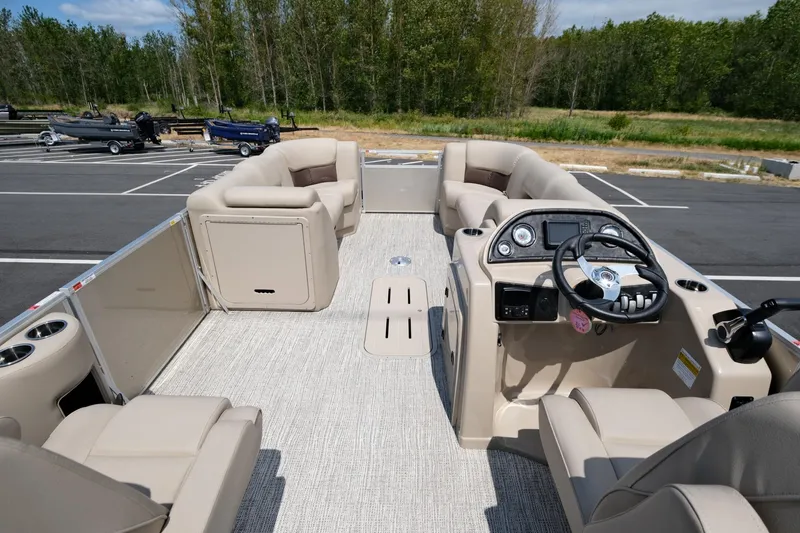 Slide: The Image of 2023 SunCatcher Fusion 322RC pontoon boat interior with plush seating and modern dashboard. - 6
