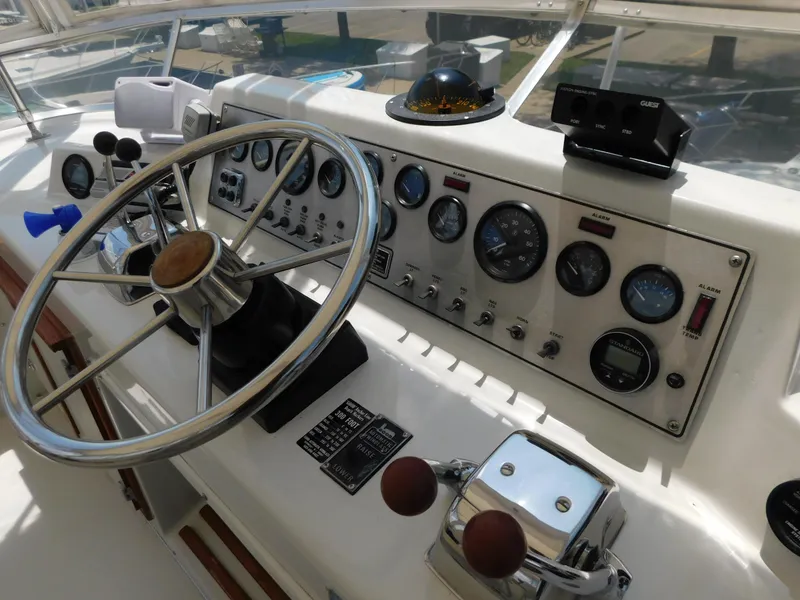 Slide: The Image of 1988 Chris-Craft 426 Catalina helm with gauges, steering wheel, and controls. - 11