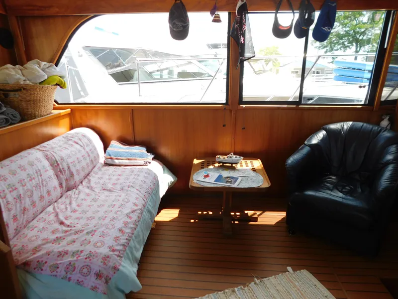 Slide: The Image of Interior of 1988 Chris-Craft 426 Catalina with cozy seating and wooden accents. - 17