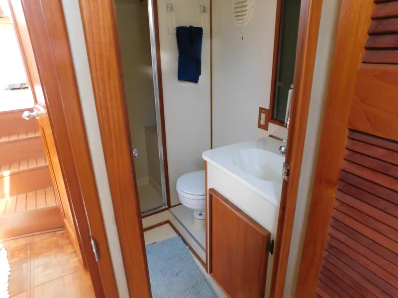 Slide: The Image of 1988 Chris-Craft 426 Catalina bathroom with wooden accents and compact design. - 24