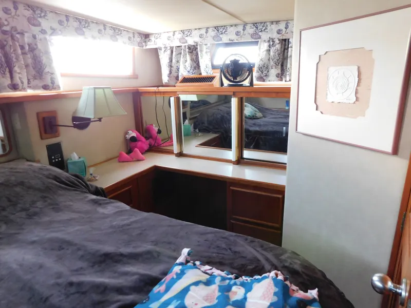 Slide: The Image of Cozy bedroom interior of 1988 Chris-Craft 426 Catalina yacht with floral curtains and decorative accents. - 28