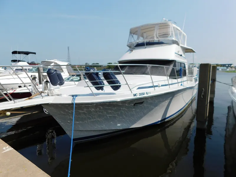 Slide: The Image of 1988 Chris-Craft 426 Catalina yacht docked at marina, featuring sleek design and spacious deck. - 31