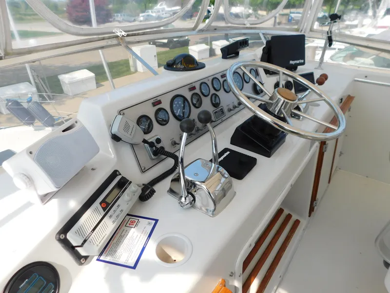 Slide: The Image of 1988 Chris-Craft 426 Catalina helm with steering wheel, gauges, and controls. - 37