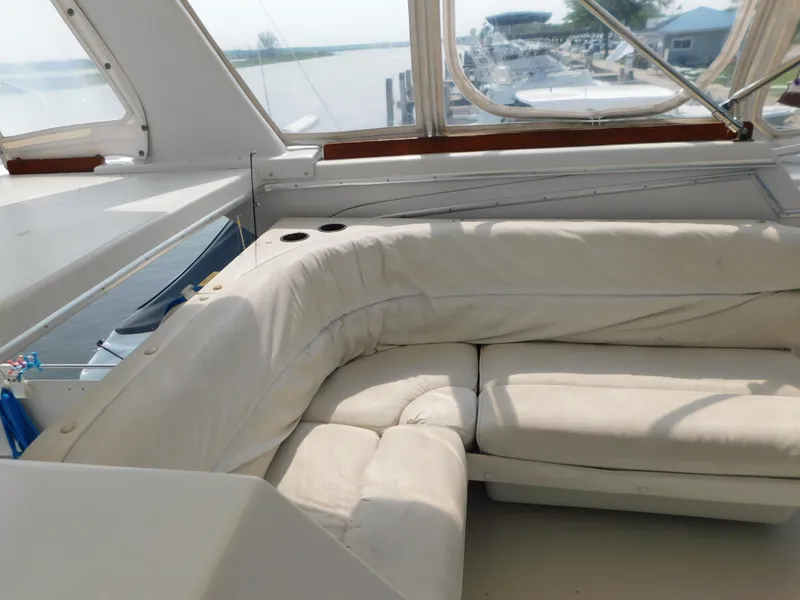 Slide: The Image of Interior view of 1988 Chris-Craft 426 Catalina yacht with white cushioned seating. - 40