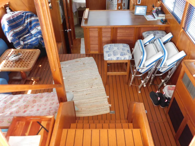 Slide: The Image of 1988 Chris-Craft 426 Catalina interior with wooden flooring and seating area. - 44