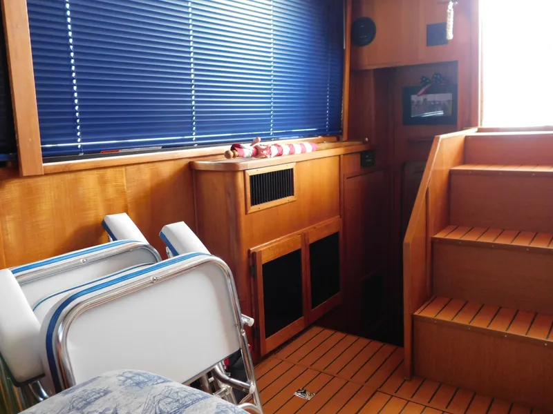 Slide: The Image of Interior of 1988 Chris-Craft 426 Catalina with wooden stairs and blue blinds. - 47