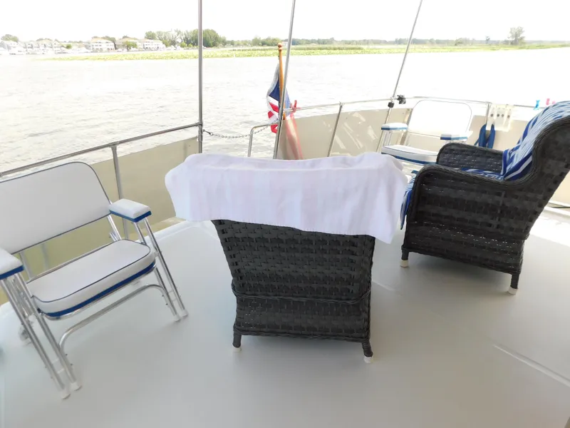 Slide: The Image of Deck of 1988 Chris-Craft 426 Catalina with chairs overlooking water. - 5