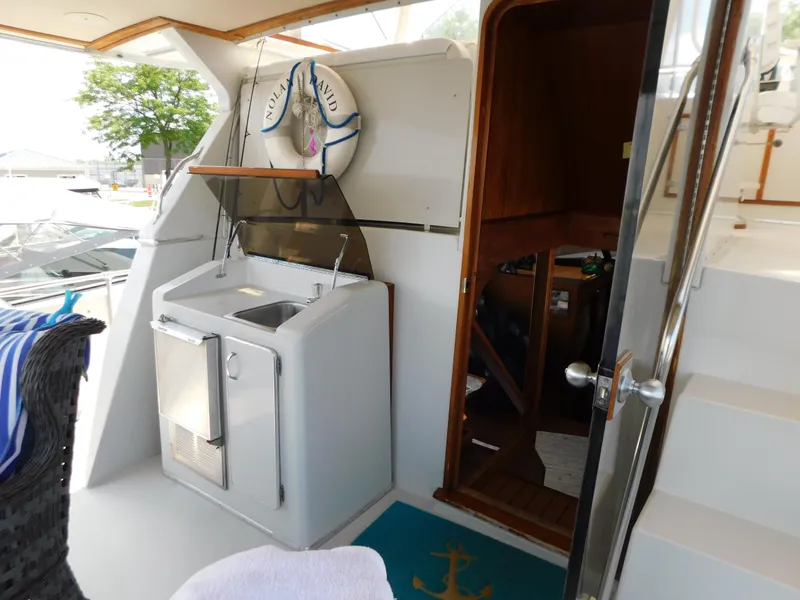 Slide: The Image of 1988 Chris-Craft 426 Catalina yacht interior with sink, life preserver, and wooden door. - 6