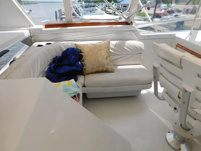 Slide: The Image of 1988 Chris-Craft 426 Catalina yacht interior with white seating and decorative pillows. - 9