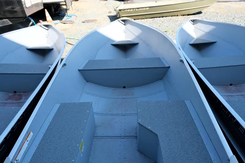 Slide: The Image of 2023 Crestliner 1261 Outreach aluminum fishing boats in a row. - 2