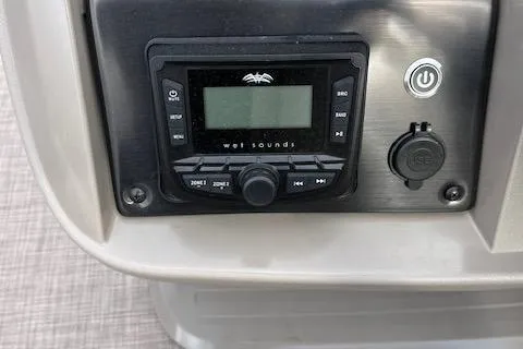 Slide: The Image of 2024 Sun Tracker SportFish 22 DLX boat stereo system and control panel. - 11