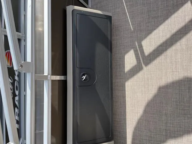 Slide: The Image of 2024 Sun Tracker SportFish 22 DLX storage compartment on deck. - 13