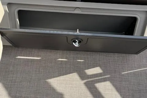 Slide: The Image of Open storage compartment on 2024 Sun Tracker SportFish 22 DLX boat. - 14