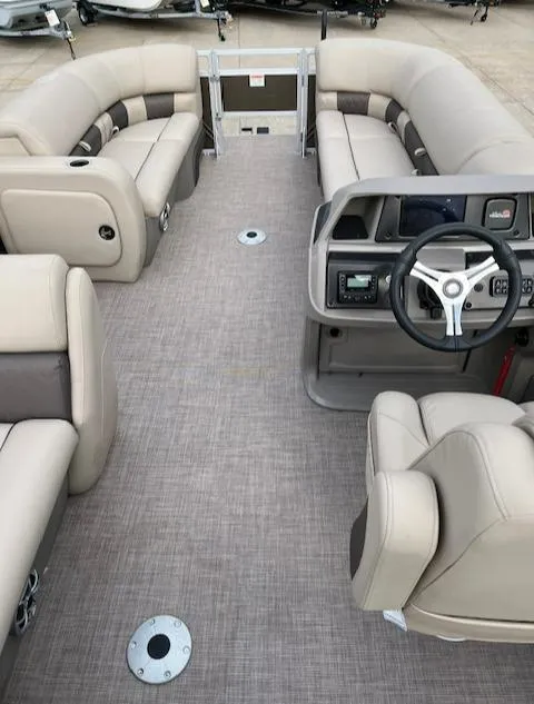 Slide: The Image of 2024 Sun Tracker SportFish 22 DLX pontoon boat interior with beige seating and modern dashboard. - 3
