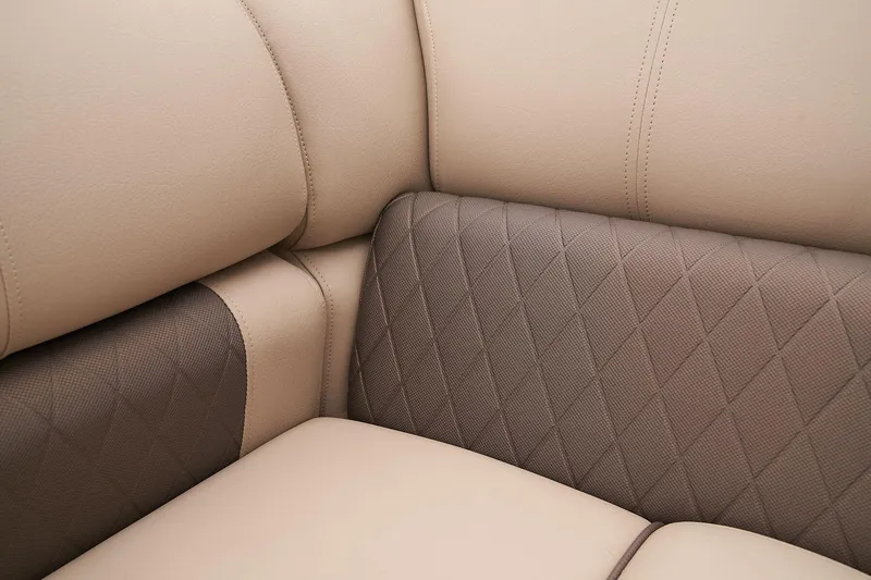 Slide: The Image of 2024 Sun Tracker SportFish 22 DLX beige and brown cushioned seating detail. - 44