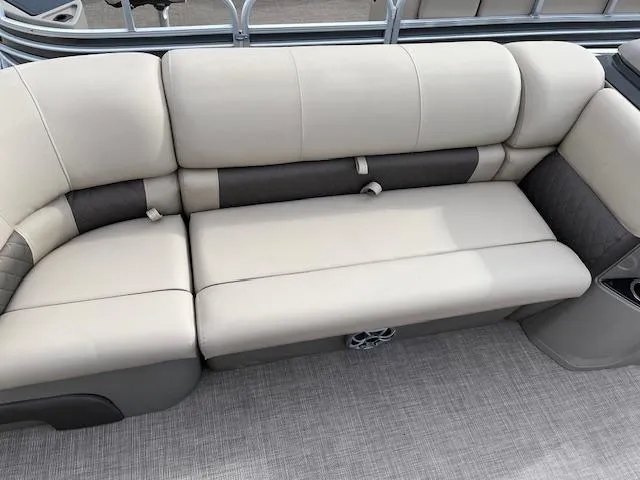 Slide: The Image of 2024 Sun Tracker SportFish 22 DLX boat interior seating with beige and gray upholstery. - 7