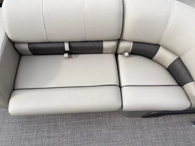 Slide: The Image of 2024 Sun Tracker SportFish 22 DLX boat seating, beige and black upholstery. - 8