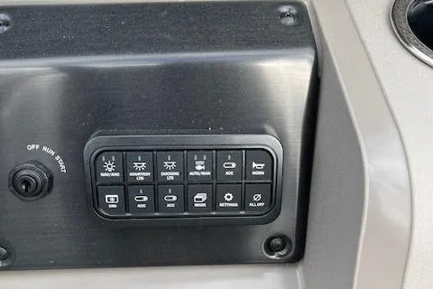 Slide: The Image of Control panel of 2024 Sun Tracker SportFish 22 DLX boat with various function buttons. - 9