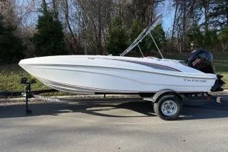 The Image of 2024 Tahoe T18 boat on trailer, parked outdoors, side view. - 1