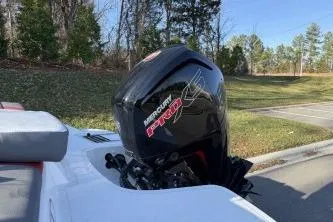 Slide: The Image of 2024 Tahoe T18 boat with Mercury Pro XS engine, parked outdoors. - 5