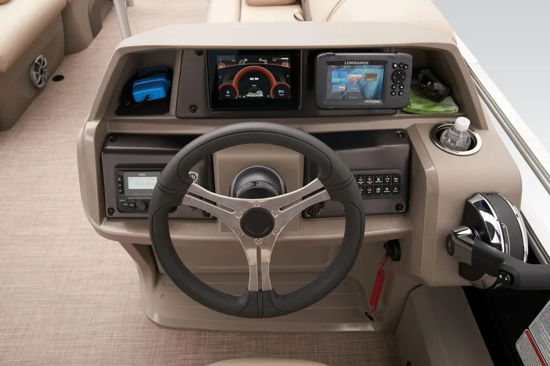 Slide: The Image of 2024 Sun Tracker SportFish 22 DLX boat dashboard with steering wheel and navigation controls. - 41