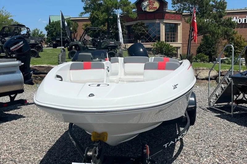 Slide: The Image of 2024 Tahoe T16 boat on display outdoors with red and gray seating. - 3