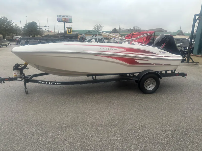 The Image of 2024 Tahoe T18 boat on trailer in parking lot. - 1
