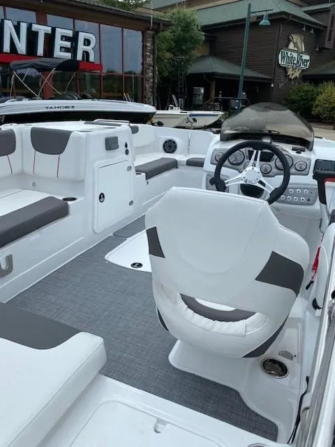 Slide: The Image of 2024 Tahoe 2150 boat interior with white seating and modern dashboard. - 3