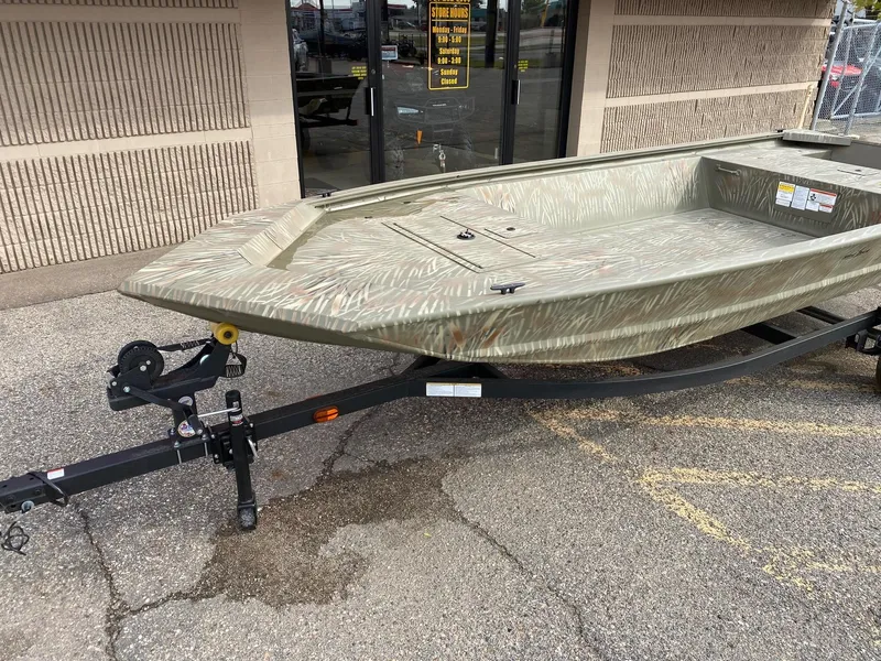 Slide: The Image of 2024 Tracker Grizzly 1648 Jon boat on a trailer outside a store. - 3