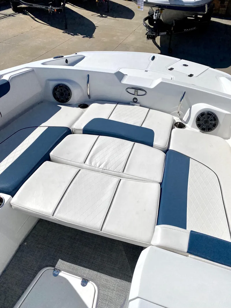 Slide: The Image of 2024 Tahoe 2150 boat interior with white and blue cushioned seating. - 6