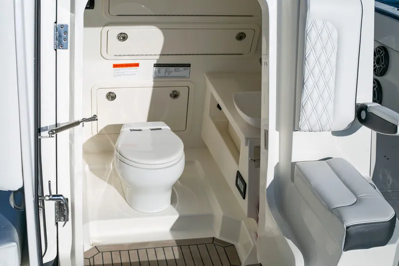 Slide: The Image of 2022 World Cat 400CC-X boat interior bathroom with toilet and sink. - 10