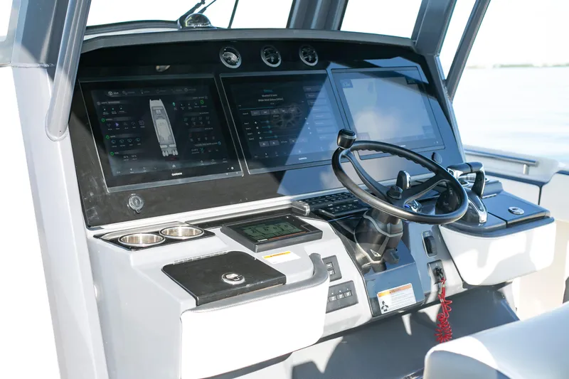 Slide: The Image of 2022 World Cat 400CC-X boat helm with advanced navigation systems and controls. - 6