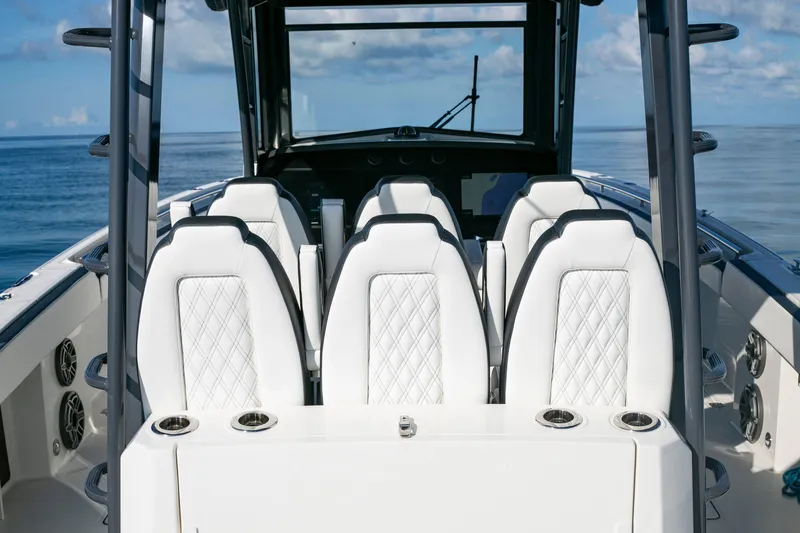 Slide: The Image of 2022 World Cat 400CC-X boat interior with white seating and ocean view. - 7