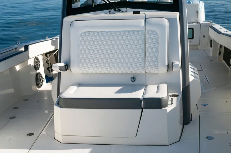 Slide: The Image of 2022 World Cat 400CC-X boat interior with cushioned seating and storage. - 9