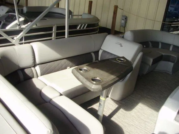 Slide: The Image of 2023 Bennington 21LSAPG pontoon boat interior with luxurious seating and table. - 4