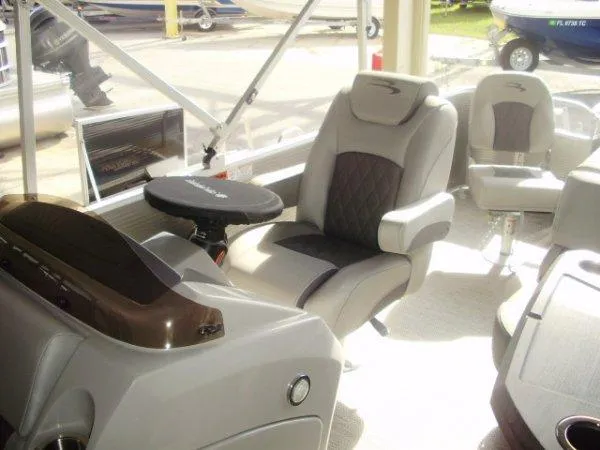 Slide: The Image of 2023 Bennington 21LSAPG pontoon boat interior with luxurious seating and modern dashboard. - 6