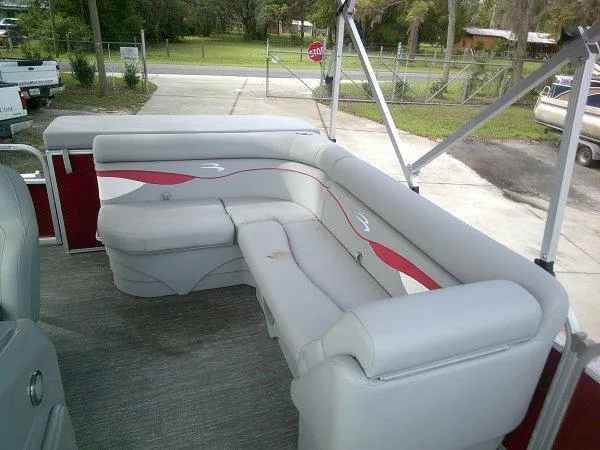 Slide: The Image of 2024 Bennington 188SVL pontoon boat with gray and red seating. - 5