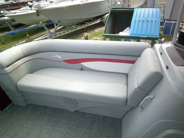 Slide: The Image of 2024 Bennington 188SVL boat interior with gray and red seating. - 7