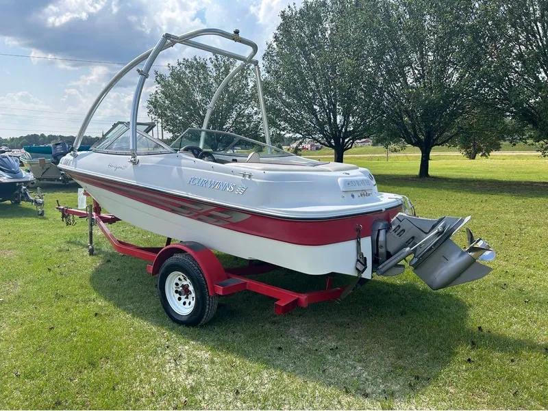 Slide: The Image of 2000 Four Winns Horizon 170 boat on a red trailer in a grassy area. - 3
