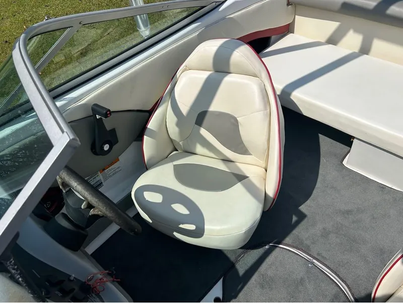 Slide: The Image of Interior of a 2000 Four Winns Horizon 170 boat showing driver's seat and steering wheel. - 9