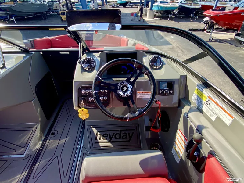 Slide: The Image of 2022 Heyday WTSurf boat cockpit with steering wheel and control panel. - 12