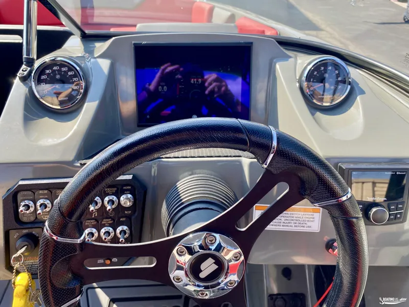 Slide: The Image of 2022 Heyday WTSurf boat dashboard with steering wheel, gauges, and control panel. - 13