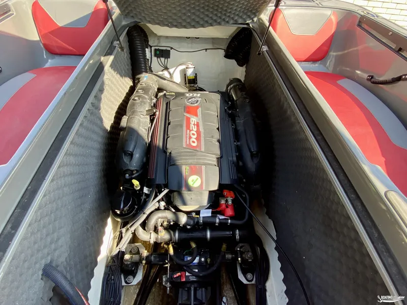 Slide: The Image of 2022 Heyday WTSurf boat engine compartment with 6200 engine, red and gray seating. - 14